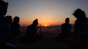 Volunteers finishing a sea turtle nest relocation by sunset